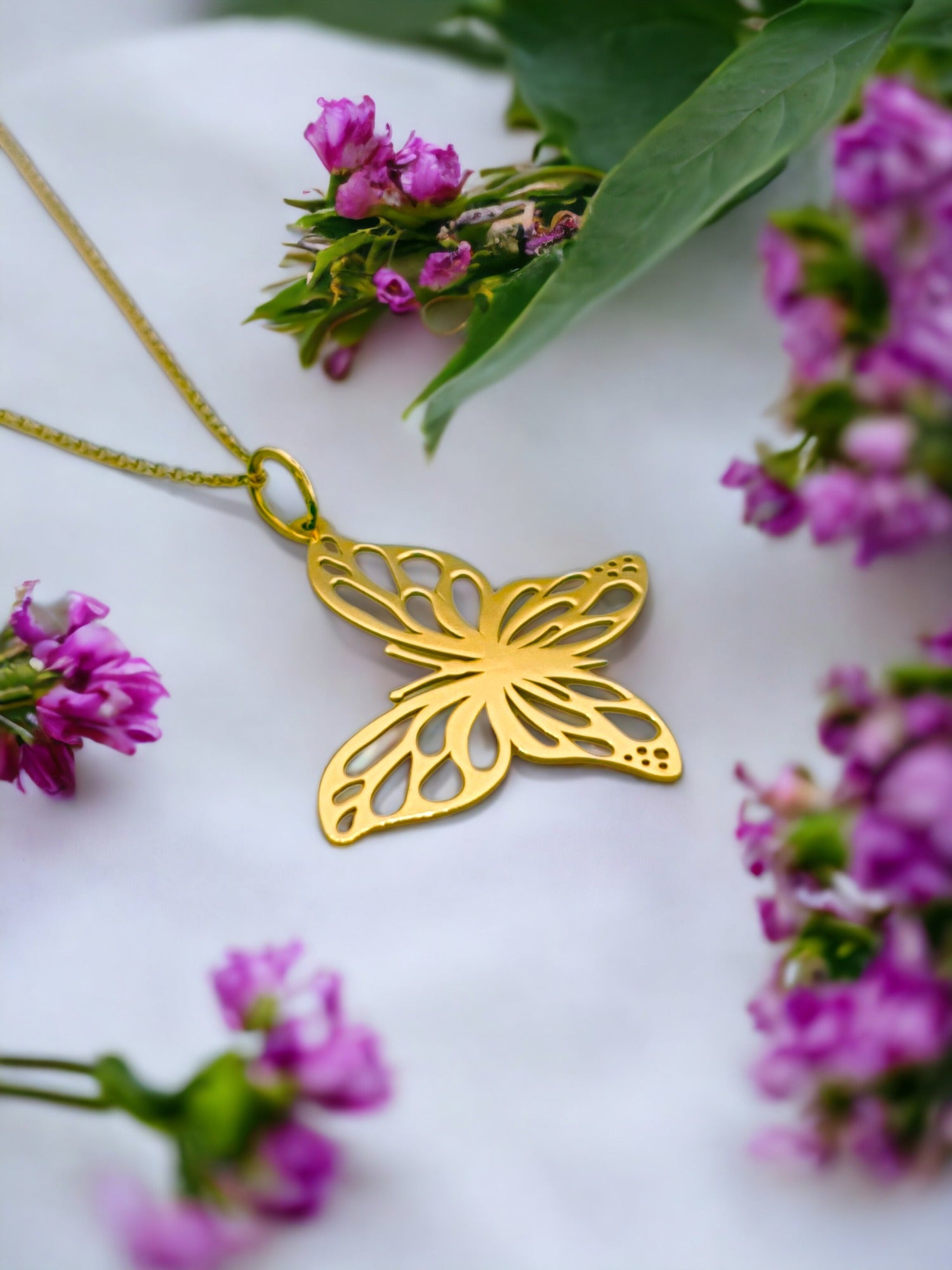 Solid 18ct gold women's butterfly necklace, lifestyle photo