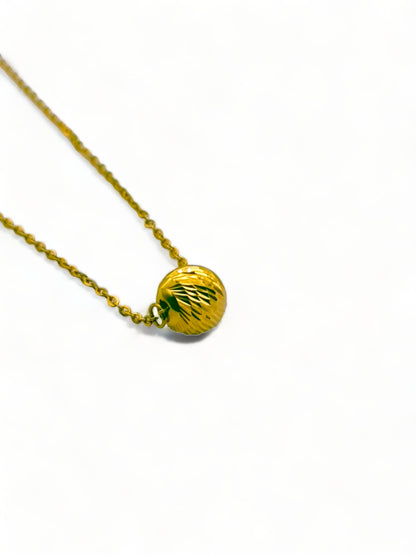 Solid 18ct gold women's disco ball necklace, sitting at an angle